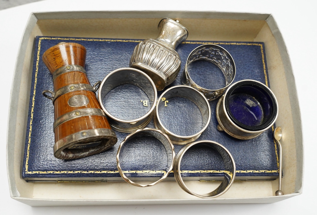 Small silver to include a cased Victorian silver Queens pattern christening trio, London 1837, four various silver napkin rings, a plated napkin ring, two condiments and a silver mounted wooden 'milk churn' pepper mill.